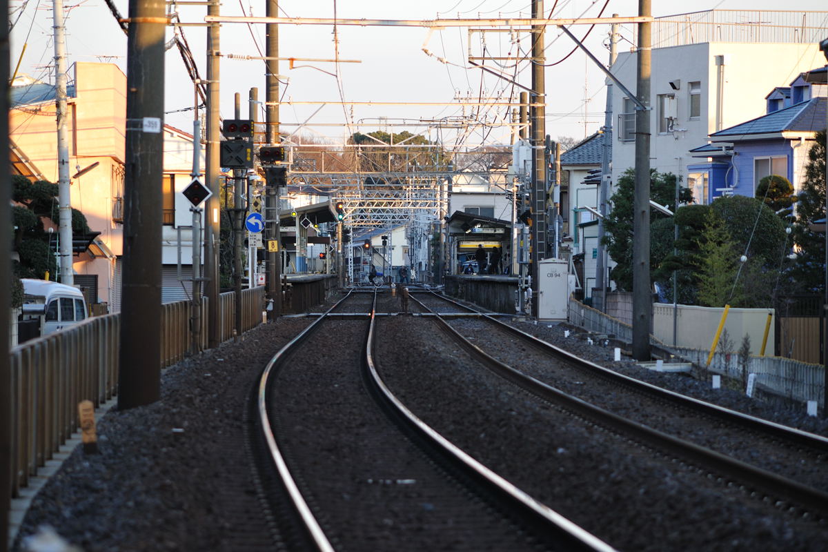 線路がカーブする辺りで振り返り中山駅を撮る